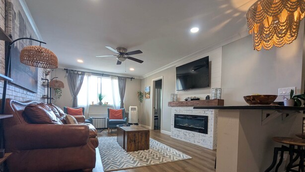 A modern living room with a sofa, coffee table, and fireplace. - Downtown/Midtown "Family ATL CityScape" (Atlanta)