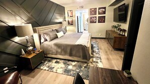A bedroom with a bed, bedside tables, a ceiling fan, a TV, and artwork on the walls. - Condominium close to New Raider’s stadium, Strip, restaurants and attractions.  (Las Vegas)