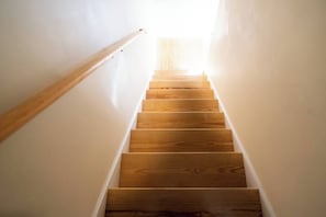 Stairs lead upwards to a bright opening.