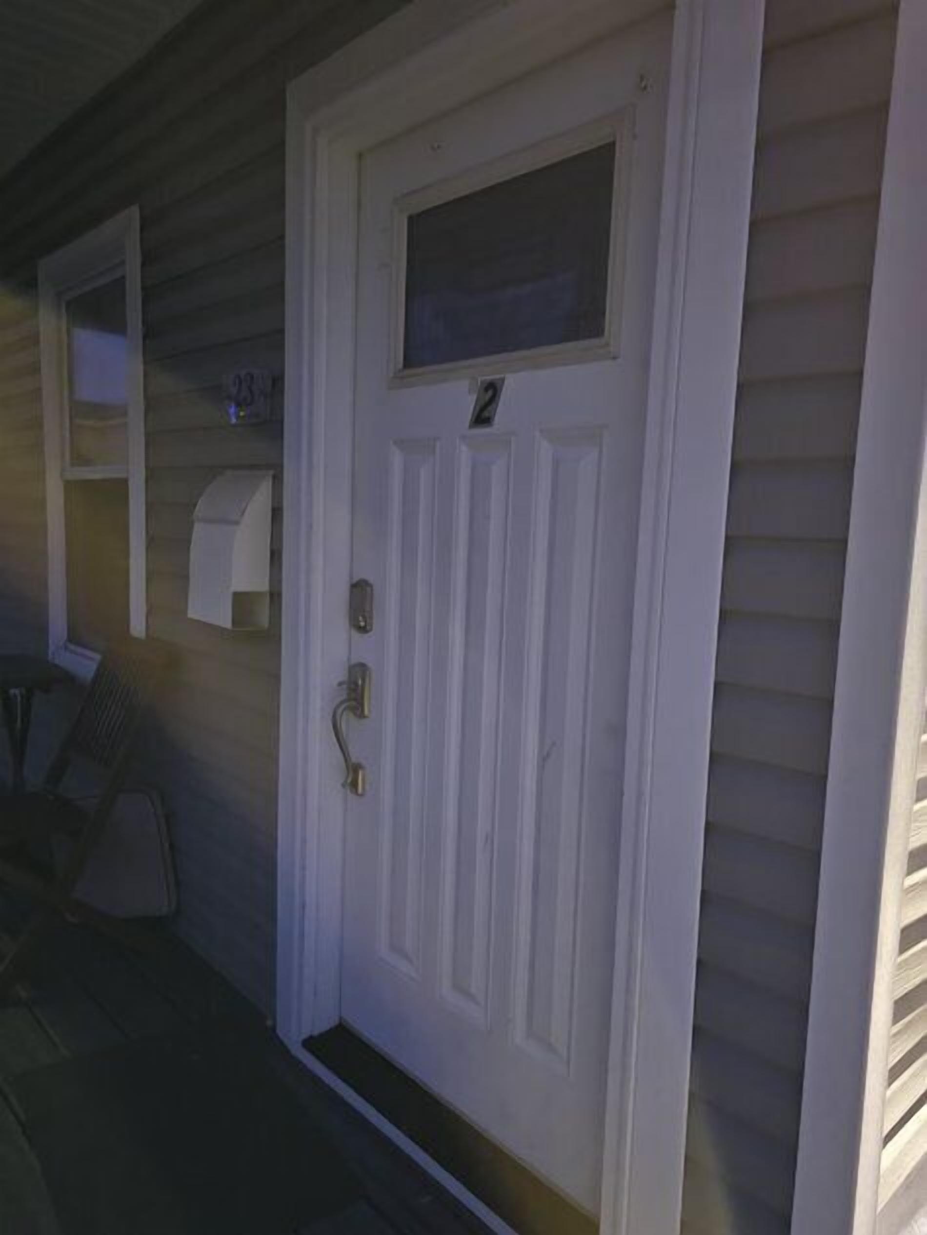 A white door with a small window and a number '2' above it.