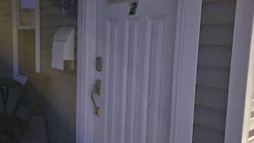 A white door with a small window and a number '2' above it.