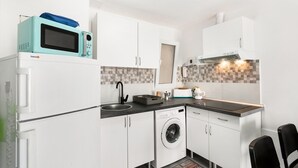 A compact kitchen with white cabinets, a washing machine, a microwave, a sink, and a toaster. - Holiday Apartment 'Bungalow Josephin' with Shared Pool, Private Terrace and Wi-Fi (Patalavaca)