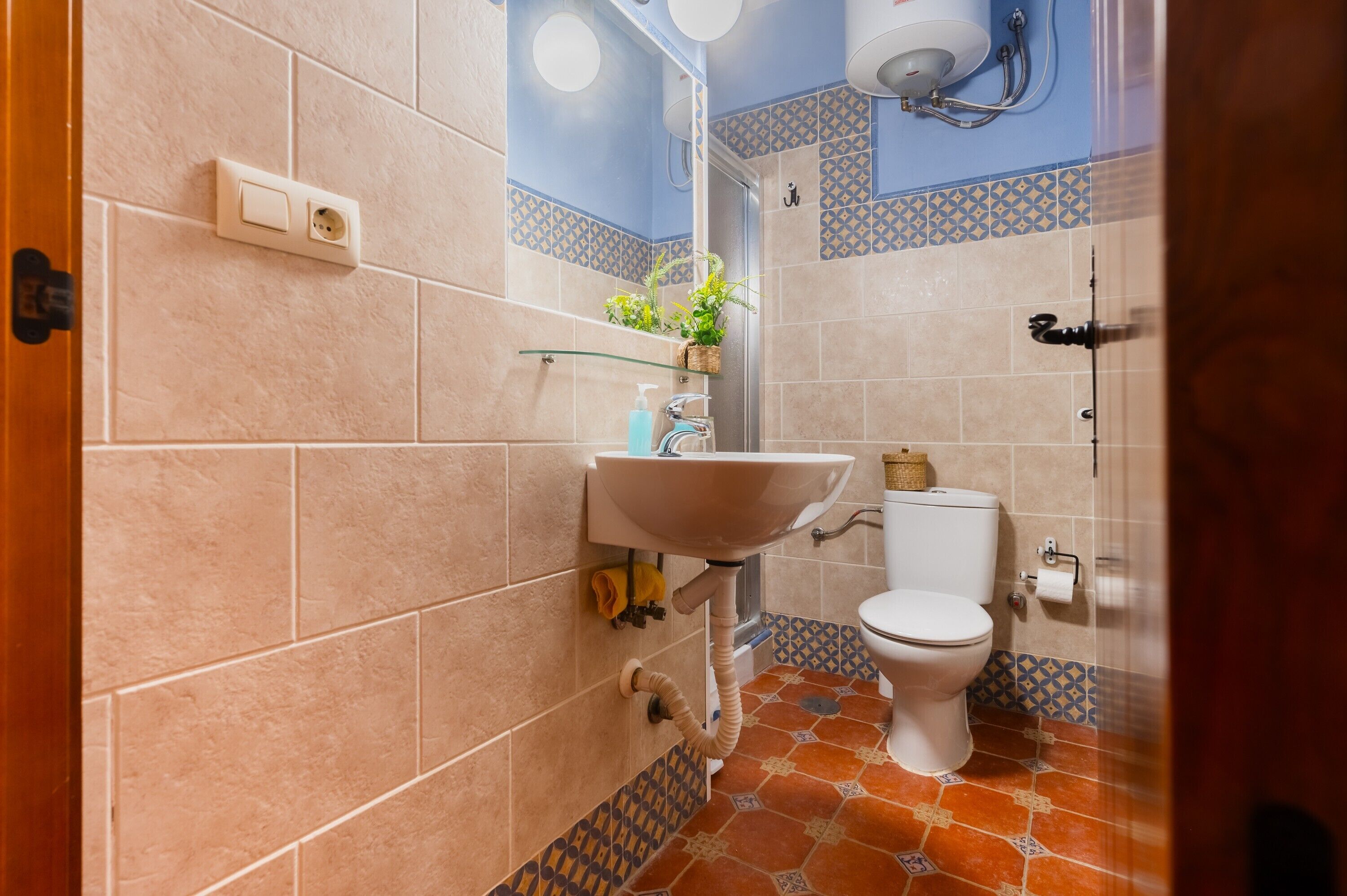 A bathroom with a sink, toilet, and shower.