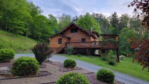 A wooden cabin with a deck and a small staircase leading to the entrance. - Quiet Luxury, Surrounded by Nature • 5-Star Guest Favorite Near Williamsport, PA (Linden)
