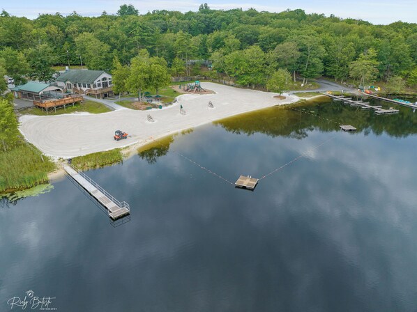 A lakeside property with a dock, a playground, and a building with a green roof. - Masthope Memories Near Narrowsburg Sleeps 8 (Lackawaxen)