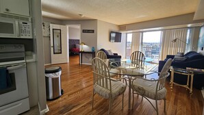 A modern apartment with a dining area, kitchen, and living room. - Quiet, Spotless Condo with King Bed for your Getaway! (Colorado Springs)