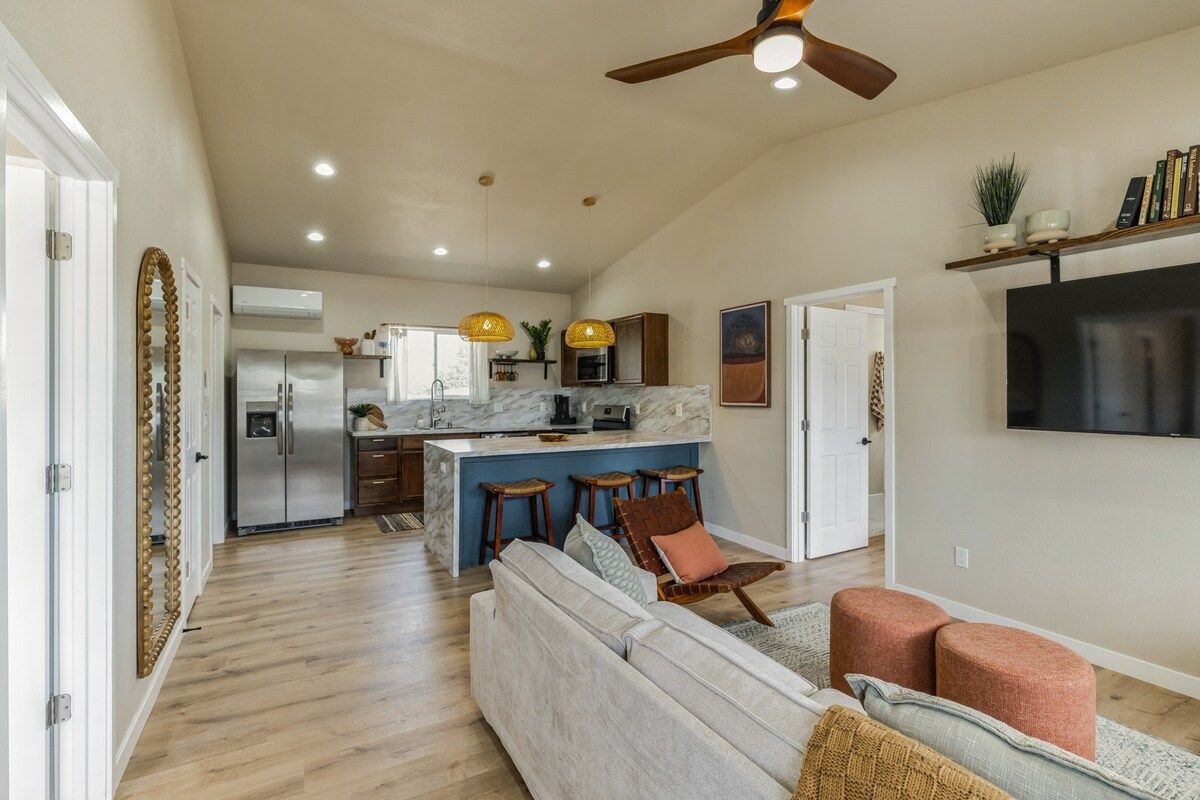 Spacious living area with comfortable seating and open kitchen views.