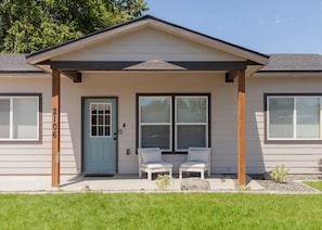 A two-story house with a front porch, two windows, and a door. - Desert Bliss - Stylish Kennewick Getaway (Kennewick)