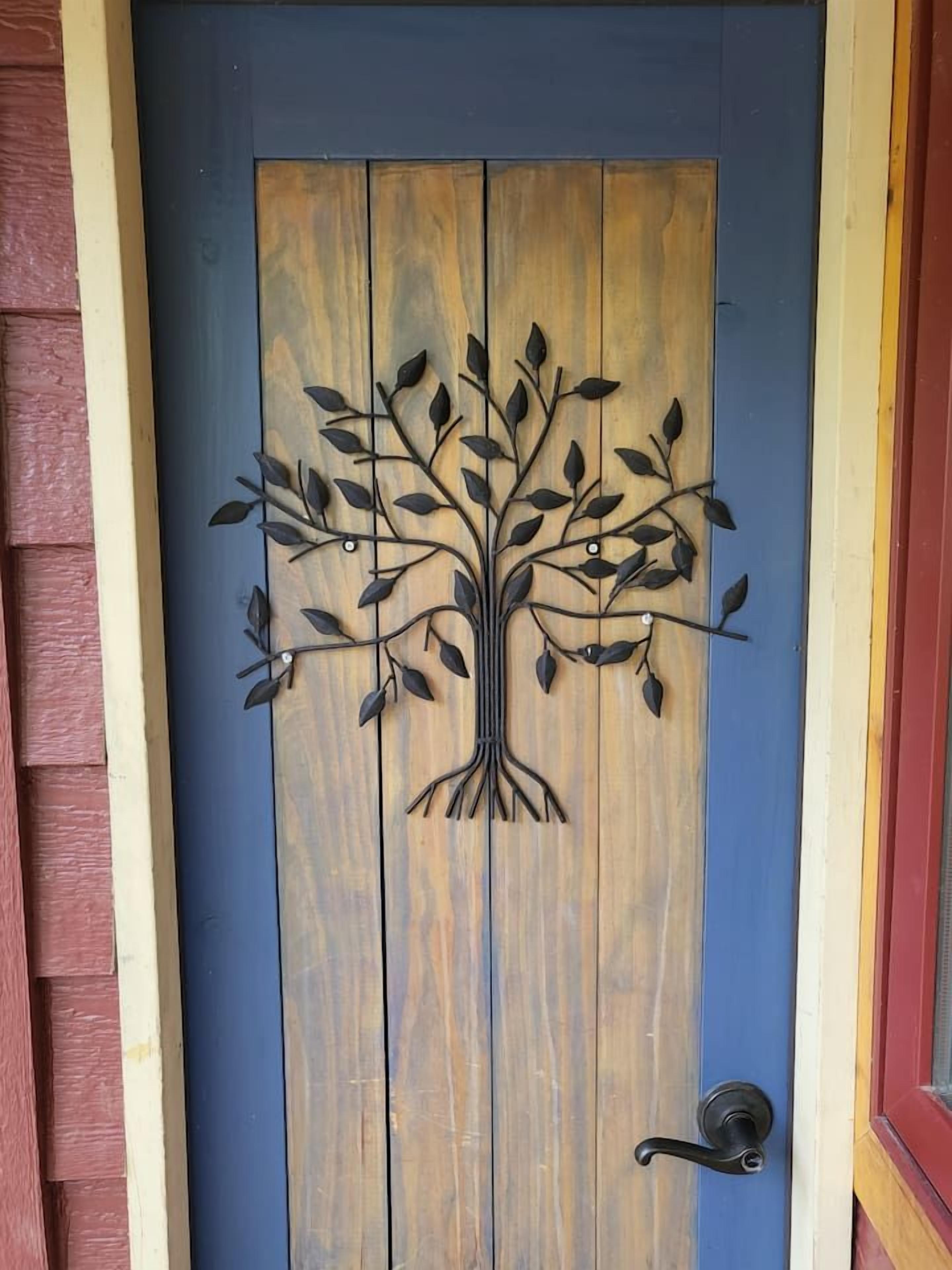A wooden door with a tree design.