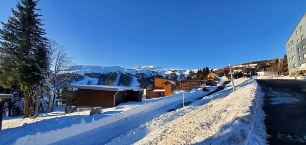 A snow-covered mountain town with buildings and a road.