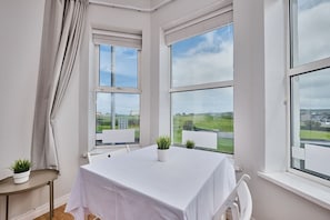 Enjoy a serene view of the surrounding landscape from the large window in this stylish room.