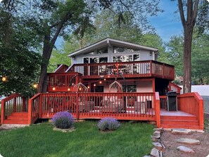 Stunning two-story building with a spacious balcony and large windows, set amidst a beautifully manicured lawn.