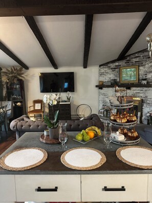 Relax in this inviting space with a comfortable sofa, dining table, and entertainment options.