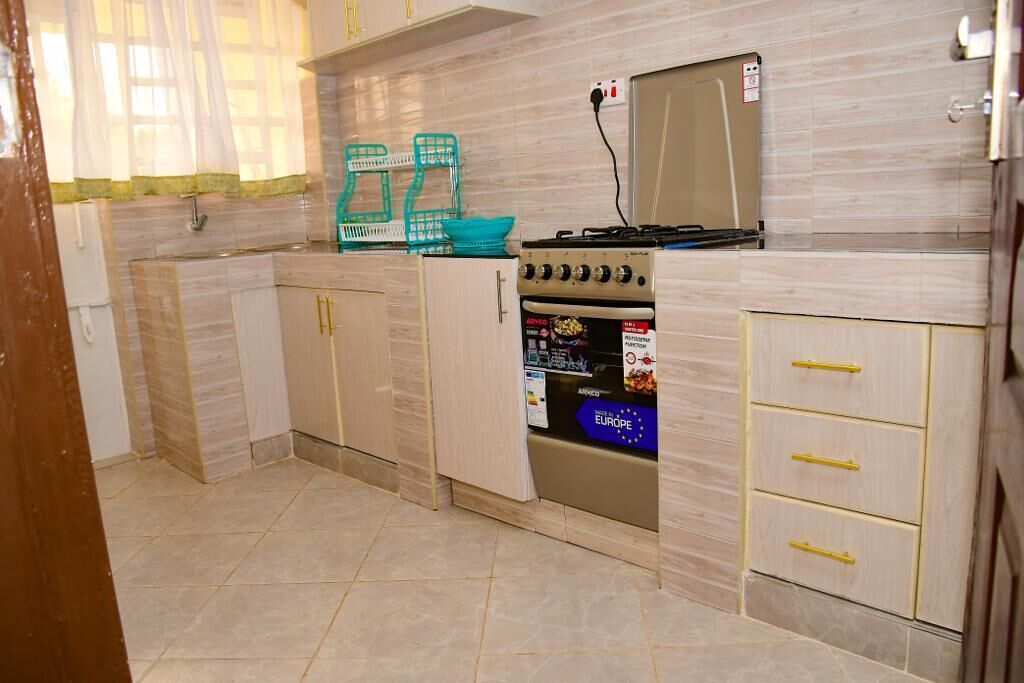 A kitchen with a stove, oven, and cabinets.