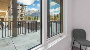 A balcony with a view of snow-capped mountains and a clear sky. - Spring Creek Vacations 2 BR Premier Condo 109TM (Canmore)