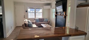 Een smart-tv, een open haard, boeken en een stereo