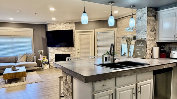 A modern kitchen with a large island, built-in appliances, and pendant lighting. - Modern North Scottsdale Condo – Resort Style Amenities, 1st Floor Corner Unit (Scottsdale)