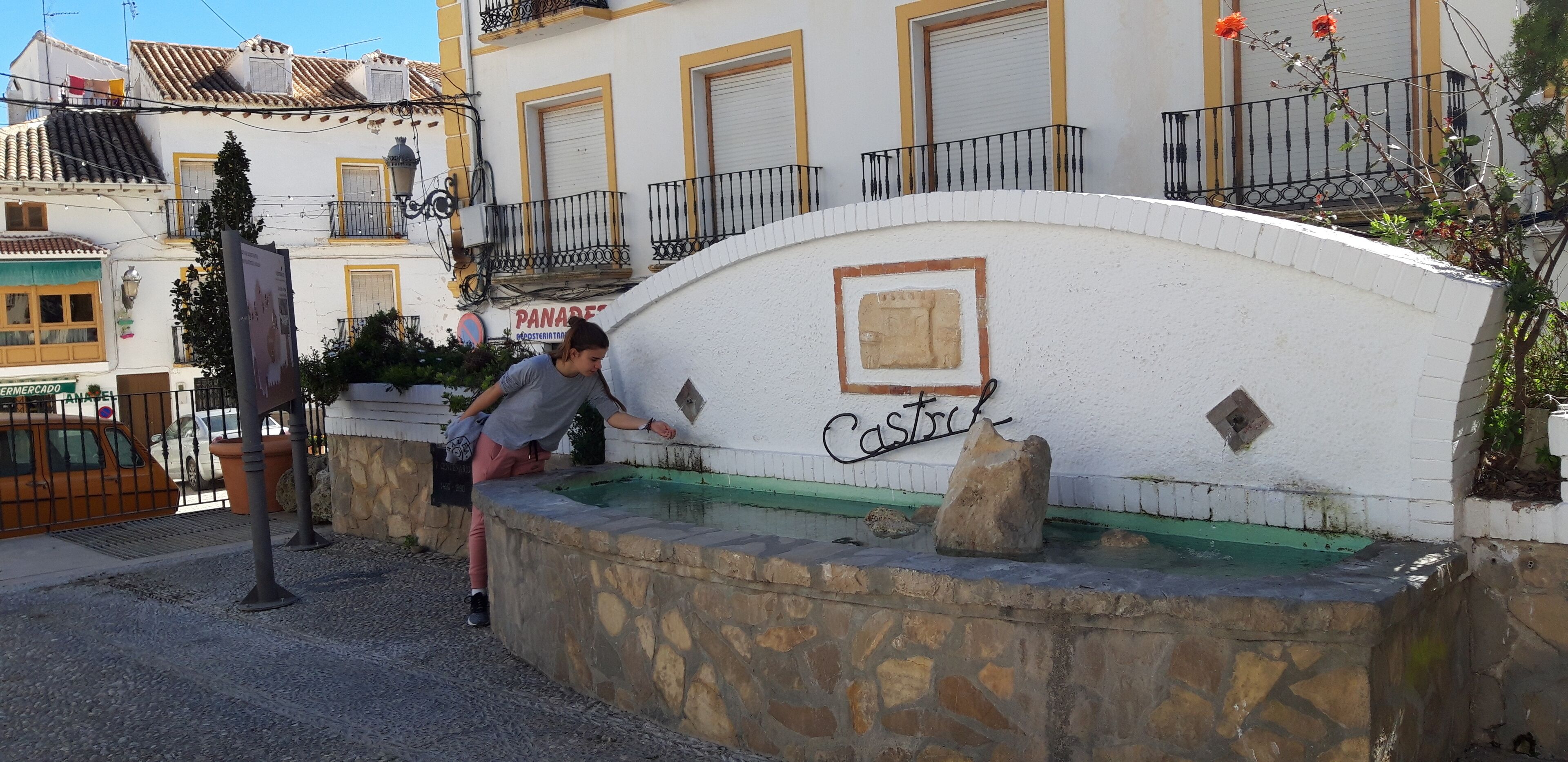 A stone wall with a fountain and the word "Castro" on it.