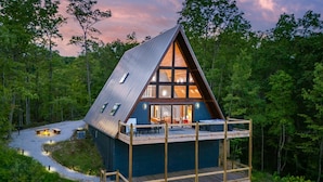 A cabin with a wooden deck, a fireplace, and a large window. - The Majestic Dragonfly Inn, overlooking Daniel Boone National Forest  (Frenchburg)