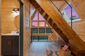A wooden interior with a skylight, a kitchen area, and a view of the outdoors. - The Majestic Dragonfly Inn, overlooking Daniel Boone National Forest  (Frenchburg)