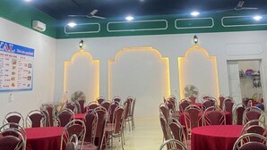 A conference room with tables and chairs, ceiling fans, and lighting fixtures. - Royal Hotel Cua Lo Beach (Cua Lo)