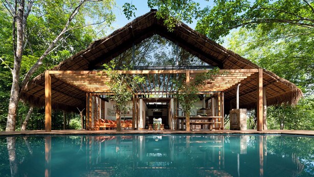 A wooden structure with a thatched roof over a pool, surrounded by trees. - Guava House by The Serendipity Collection (Hemmathagama)