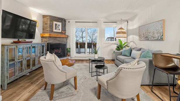 A modern living room with a fireplace, a television, and comfortable seating.