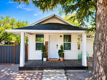 A single-story house with a front porch, a welcome sign, and a mailbox.. Firepit | off I-80 | Private Carport |1BR | Pets