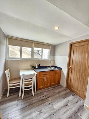 Rooftop King Room | Private kitchen | Fridge, cookware/dishes/utensils, cleaning supplies, dining tables