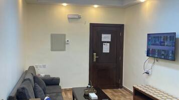 Comfort Studio | Living area | 50-inch Smart TV with satellite channels