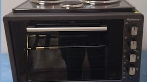 A black portable oven with three control knobs and a digital display. - Spacious apartment nearby restaurants, cafes and 2 minutes walk from the metro!
 (Athens)