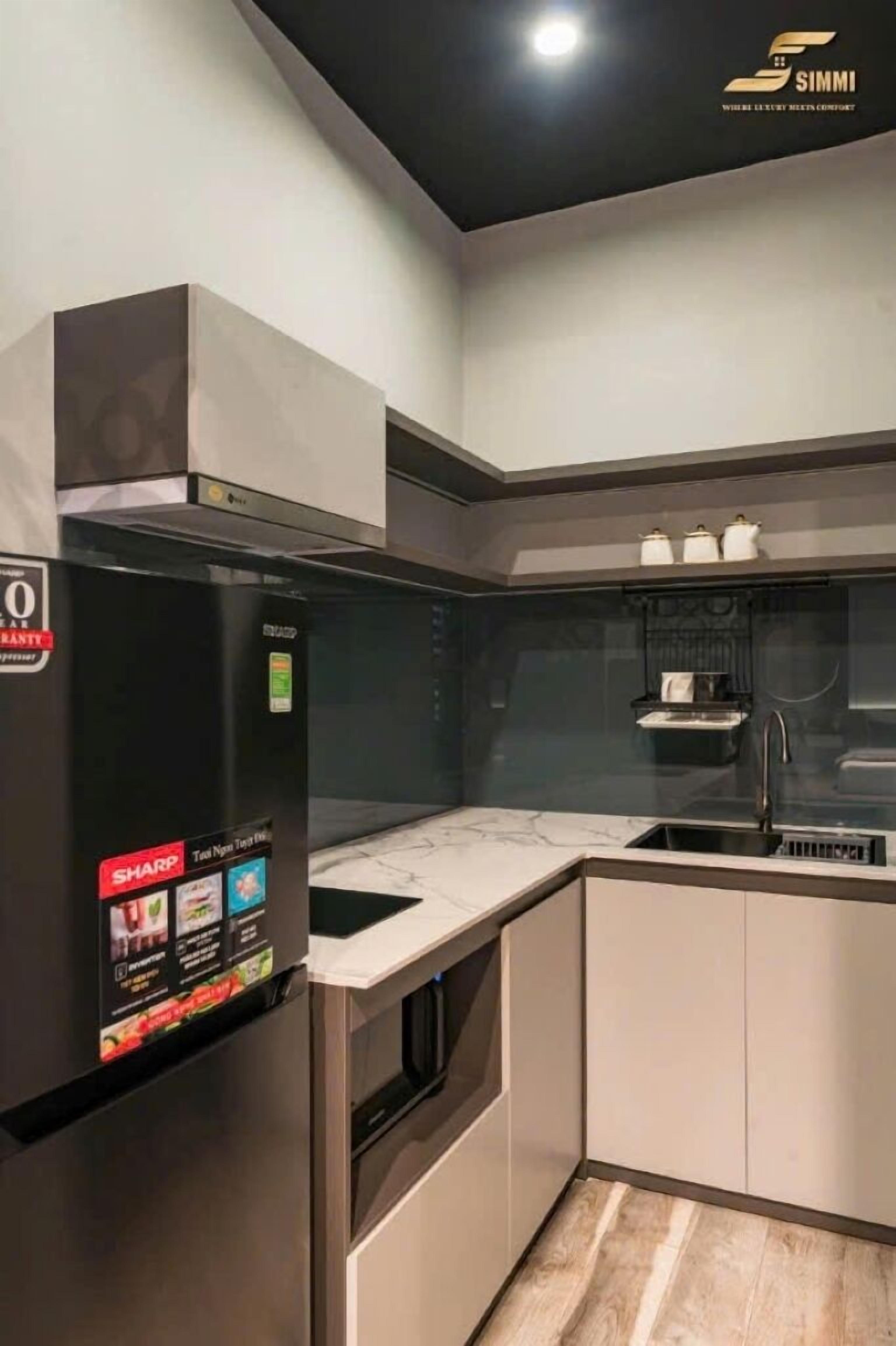 A modern kitchen with a built-in refrigerator, a sink, and a stove.