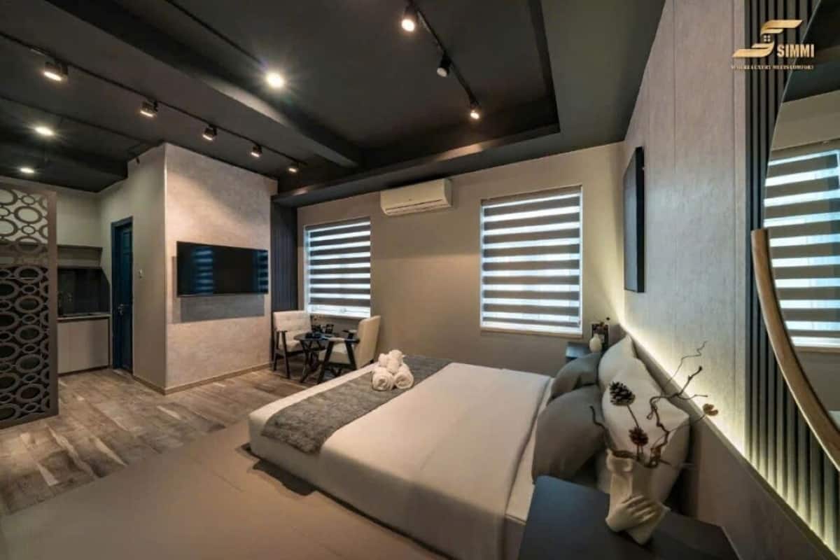 Een moderne hotelkamer met een groot bed, een bureau en een zithoek.
