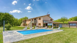 A two-story house with a swimming pool, outdoor seating, and a stone facade. - Grad Inn Room Marjoram With Pool (Koper)