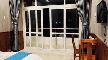 Desk, laptop workspace, blackout drapes, iron/ironing board