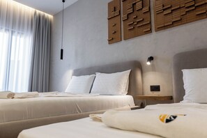 Habitación triple superior | Insonorización y ropa de cama 
