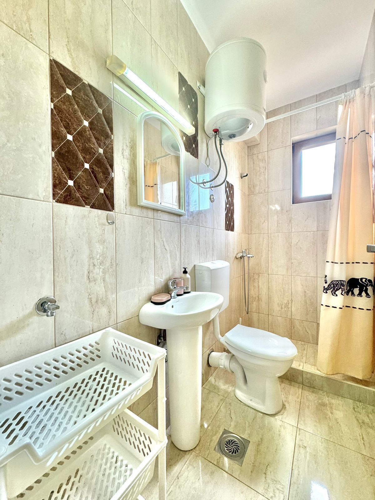 A bathroom with a sink, toilet, and shower.