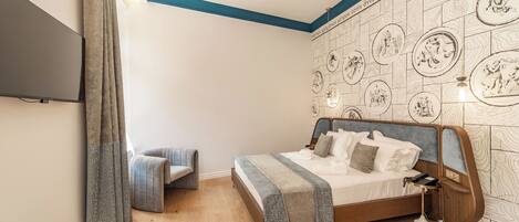 A bedroom with a bed, bedside table, and a wall with a patterned design.