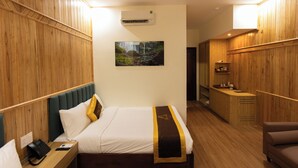 A hotel room with a bed, bedside table, phone, and a picture on the wall. - LuckyStar Hotel (Pleiku)