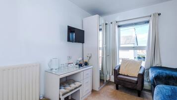 Premium bedding, desk, laptop workspace, blackout curtains