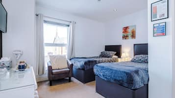 Premium bedding, desk, laptop workspace, blackout curtains