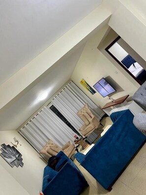Business Apartment | Living area | 32-inch Smart TV with digital channels - Lux Suites Mango Court Apartments (Nairobi)