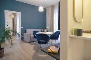 Family Apartment, Balcony, Partial Lake View | Living area | 32-inch flat-screen TV with cable channels