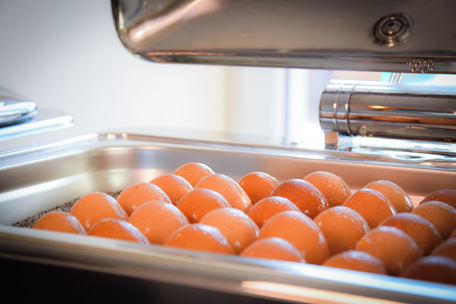A tray of round, orange-colored items in a kitchen setting.