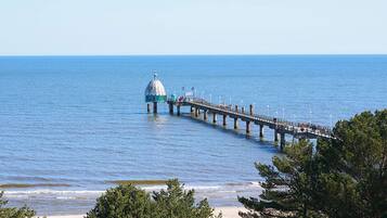 A pier extending into the water with a dome structure at the end.