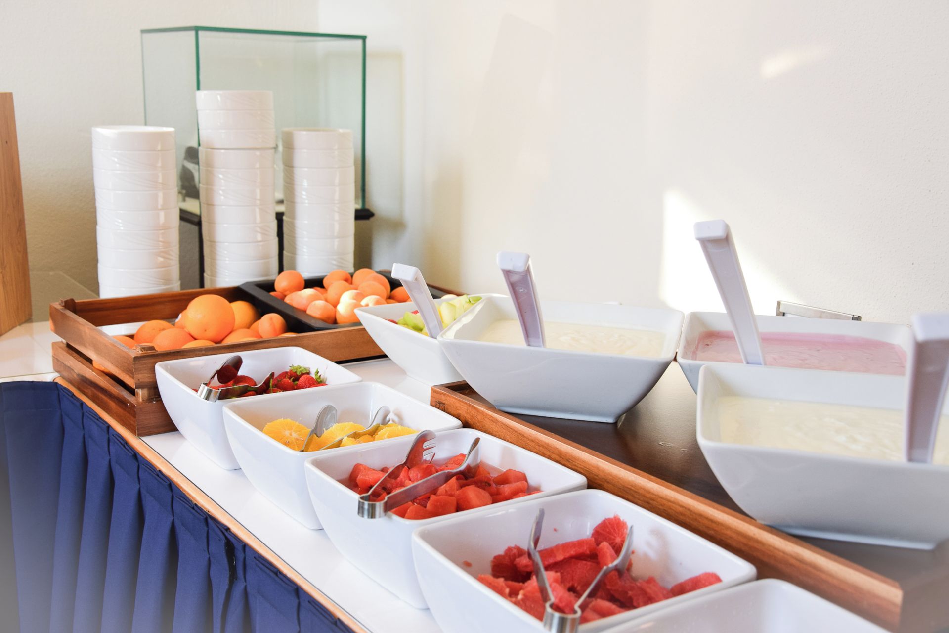 A buffet with various food items and utensils.