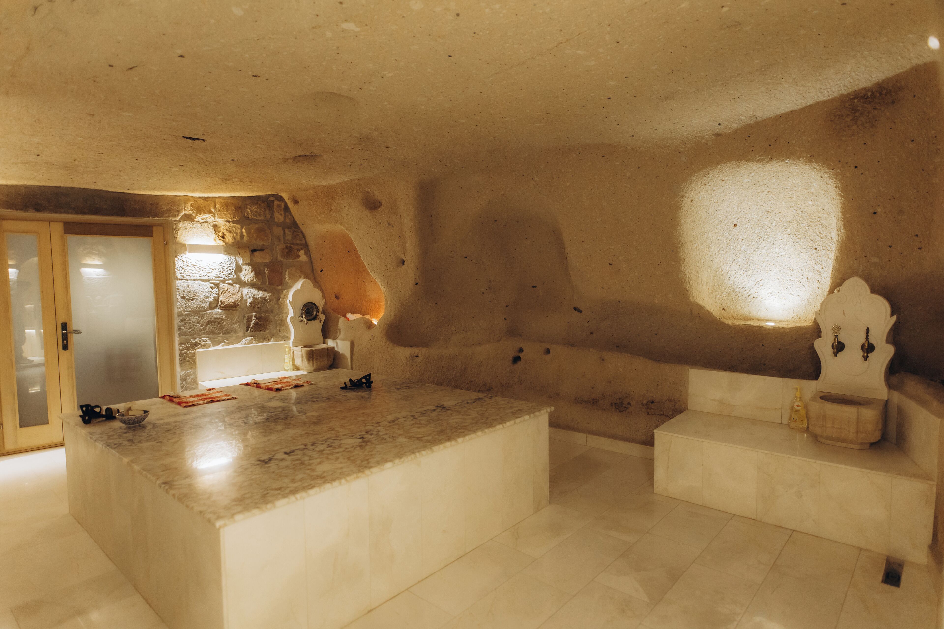 A spacious bathroom with a large marble sink, a bathtub, and a shower area.