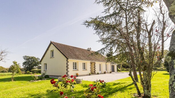 A two-story house with a sloped roof, a front porch, and a driveway leading to the entrance. - Single-story house with garden and parking in Yvetot-Bocage (Yvetot-Bocage)