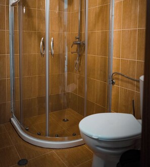 A shower enclosure with a glass door, a toilet, and a showerhead. - Apartment - Sleeps 4 & Free Parking (Nessebar)