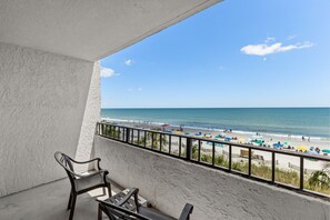 A balcony with a view of a beach. - Ocean Reef Resort Unit 408 - Oceanfront (Myrtle Beach)